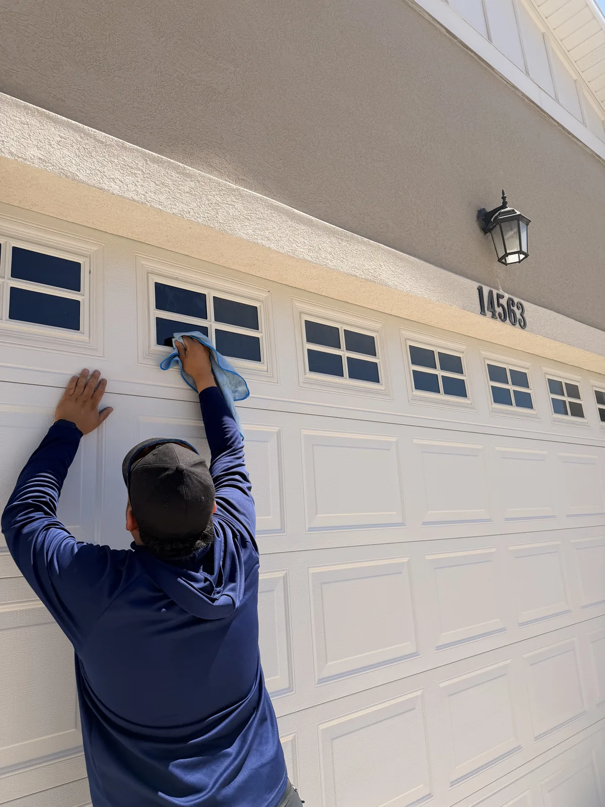 Technician Cleaning Garage Windows Utah